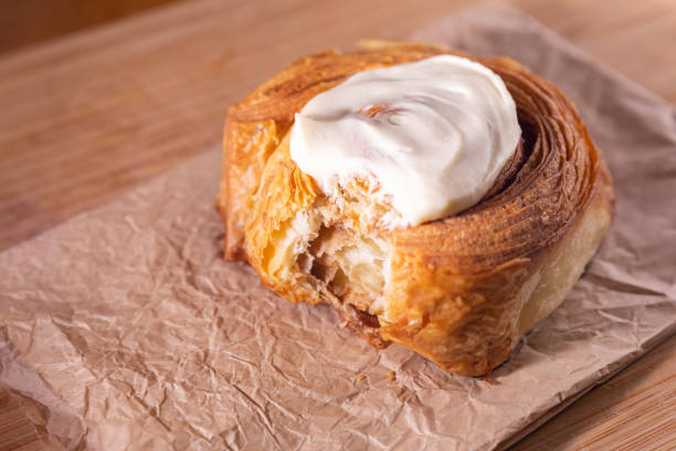 istock Cinnamon bun made with butter laminated croissant dough and cream cheese icing 1308147758
