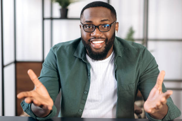 istock Successful friendly multiracial black male freelancer,  business leader or tutor, speaking during video conference with colleagues or friends, gesturing hands and smiling, talks about plans,strategy 1308148791
