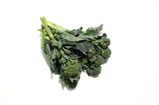 Pictured tenderstem broccoli in a white background.