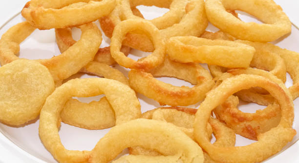 istock Onion rings in batter cooked on white plate 1308154284