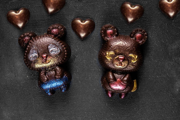 istock two hand crafted chocolate bears and many hearts 1308156664