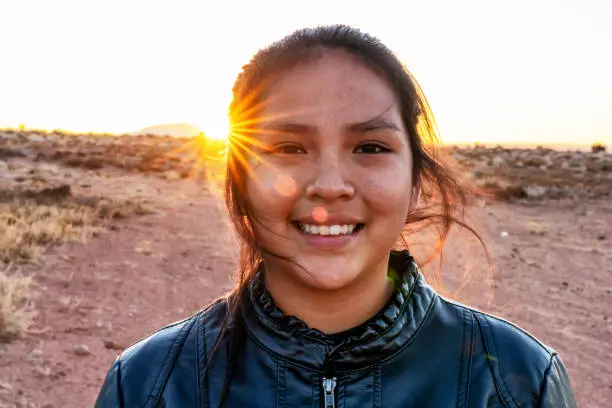 A Close Up Portrait Of A Navajo Native American Young Woman Near Her Home In Monument Valley, Utah