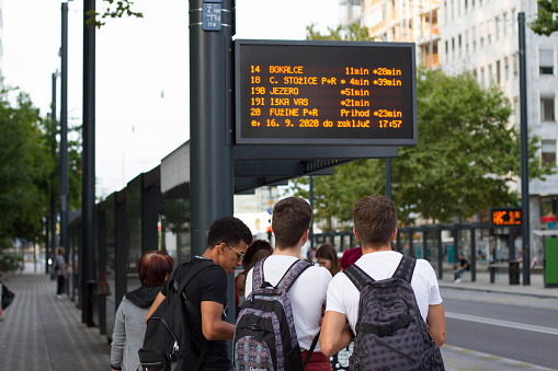 Ljubljana, Slovenia. 16.8.2020. Teenagers waiting on the bus stop. Male students waiting on the public transportation.