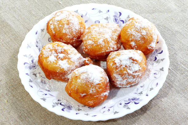 istock Doughnuts on a white plate. Sweet pastry on a linen fabric. Powdered sugar. 1308162093