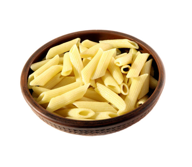 istock Pasta. Penne in a clay plate isolated. 1308163188