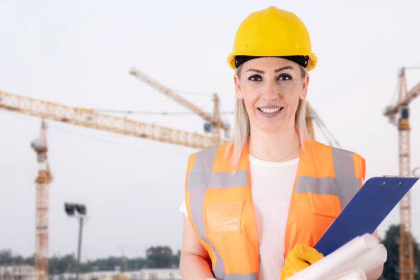 istock woman holding projects at construction area 1308164009