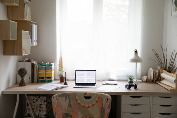 istock Empty desk with laptop and paperwork at home 1308167353