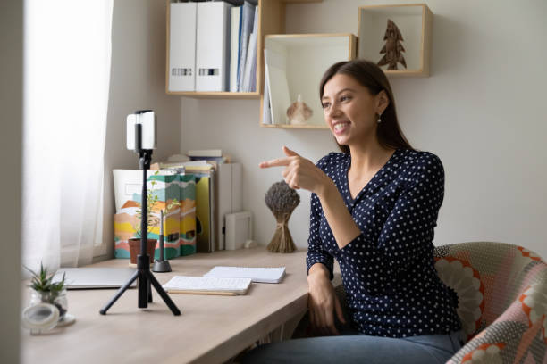 istock Young woman tutor record vlog on smartphone 1308167378