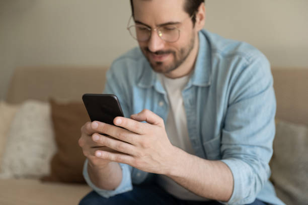 istock Millennial man texting on modern smartphone at home 1308167457