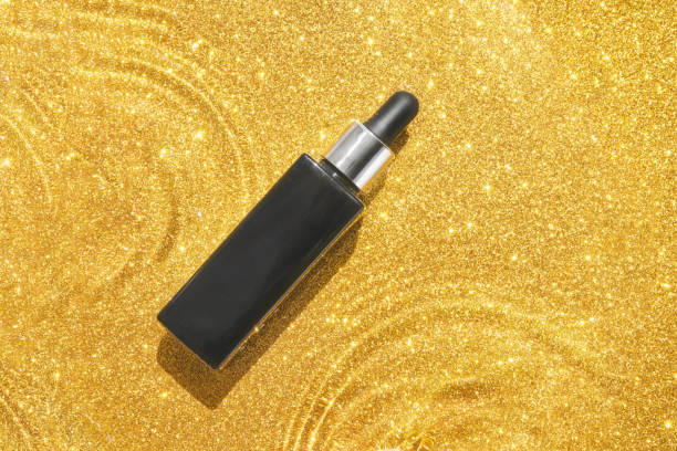 Water circle with sparkles background. Black serum bottle. Copyspace mockup