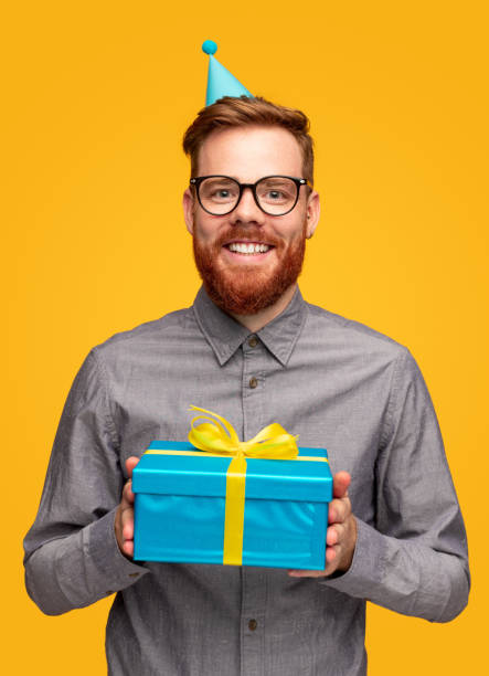 istock Joyful bearded man with birthday gift box 1308167664