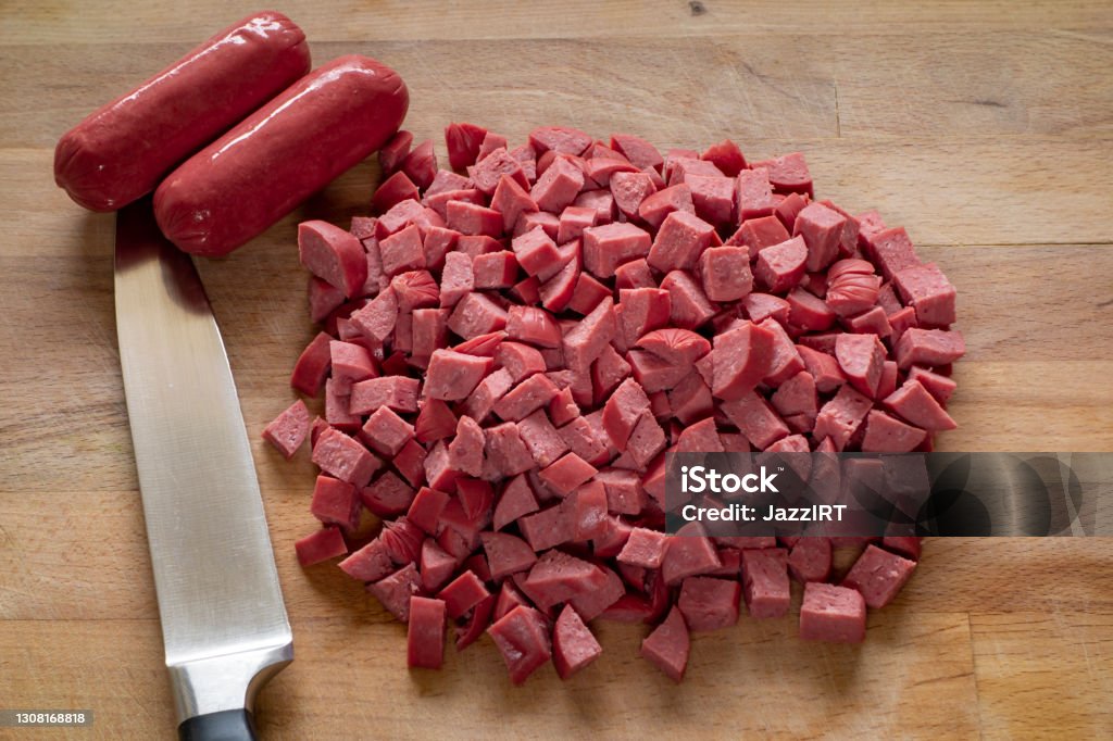 Sausage with knife over cutting board Sausage Stock Photo