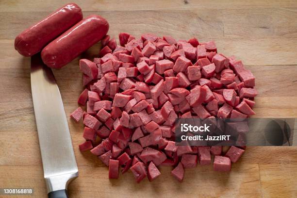 Sausage With Knife Over Cutting Board Stock Photo - Download Image Now - Sausage, Chopped Food, Slice of Food
