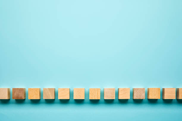 Blocks in a row on a blue background Blocks in a row on a blue background at the bottom of photos stock pictures, royalty-free photos & images