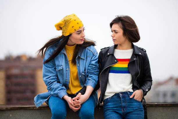 Lesbian couple having discussion on rooftop stock photo