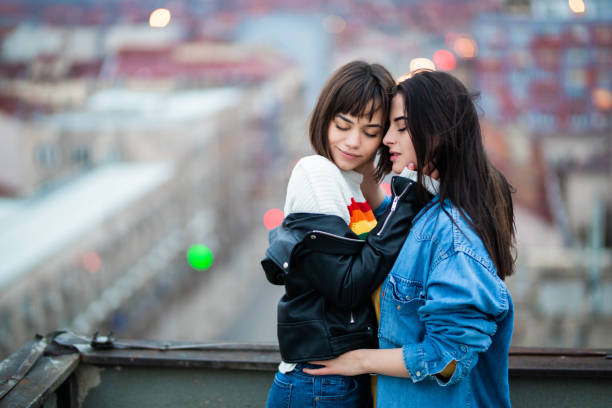 istock Young lgbt couple on rooftop 1308170820