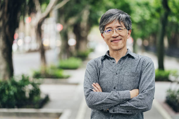 istock Smiling mid age Asian ethnicity man with eyeglasses 1308172109