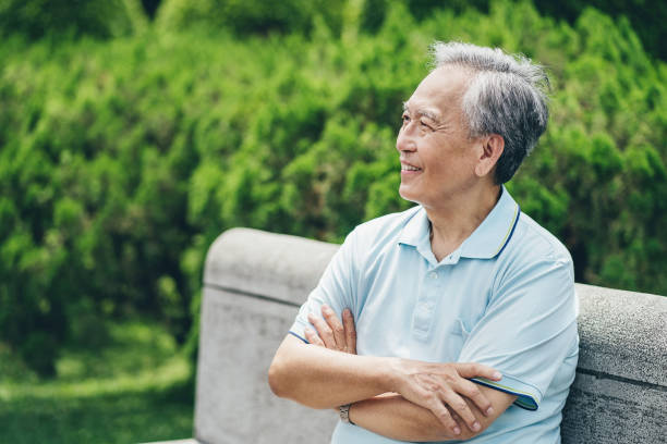 istock Smiling senior man resting in the park 1308172113