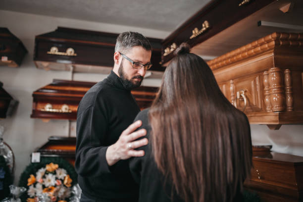 the man comforts the widow - funeral family sadness depression imagens e fotografias de stock