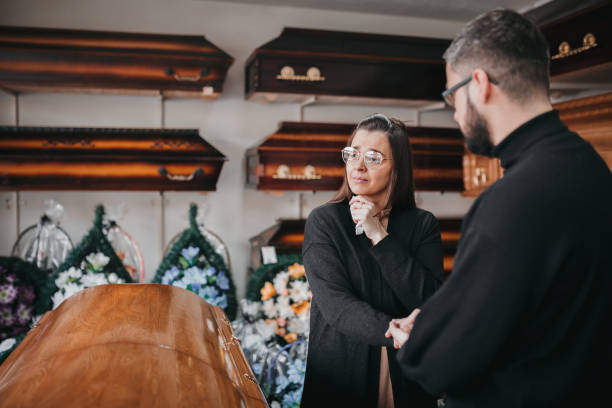 man comfort a woman in funeral parlor - funeral family sadness depression imagens e fotografias de stock