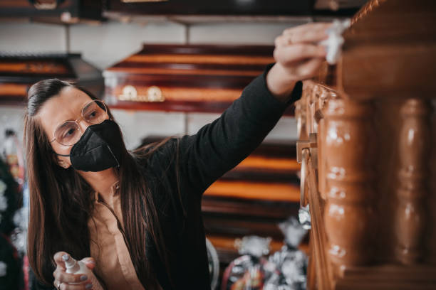 A worker cleans the funeral equipment shop