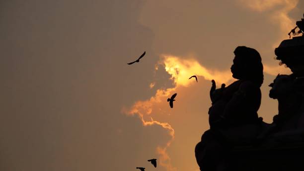 istock Hindu Statues In Silhouette At Sunset 1308180465