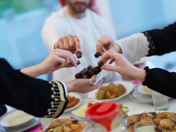 Muslim family having iftar together during Ramadan Muslim family having iftar together during Ramadan. Arabian people gathering for traditional dinner during fasting month. iftar photos stock pictures, royalty-free photos & images