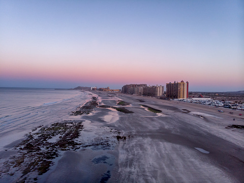 Sandy Beach of Puerto Peñasco Resort Mexican Town at Dusk with Various Hotels in the Distance and Very Few People