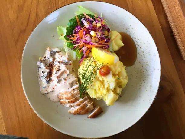 This photo was taken in Pengilon as healthy restaurant in Yogyakarta. The food consists of mashed potato, vegetable salad, and chicken with delicious sauce.