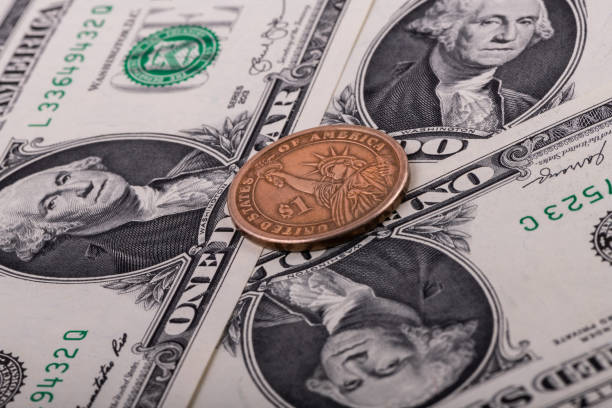 istock Three 1 American dollar bills and 1 USD coin 1308191175