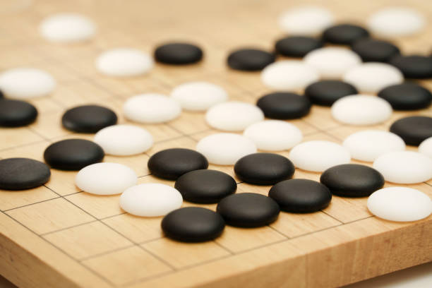 istock Go game stones in wooden board 1308192080