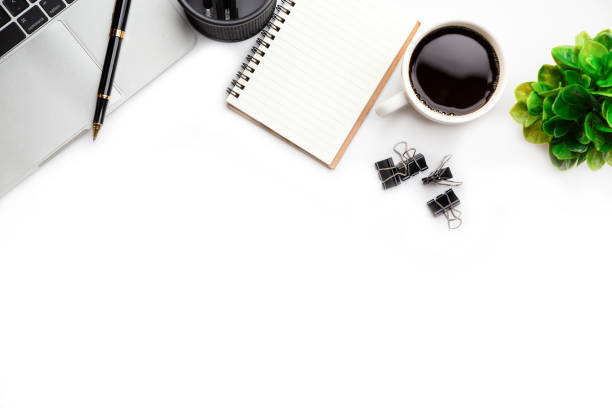 istock Flat lay, top view office table desk. Workspace with, laptop,office supplies, pencil, green leaf, and coffee cup on white background. 1308192427