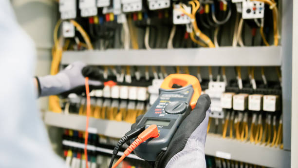 istock Electrical engineers test electrical installations and wiring on protective relays, measuring them with a multimeter. 1308192454