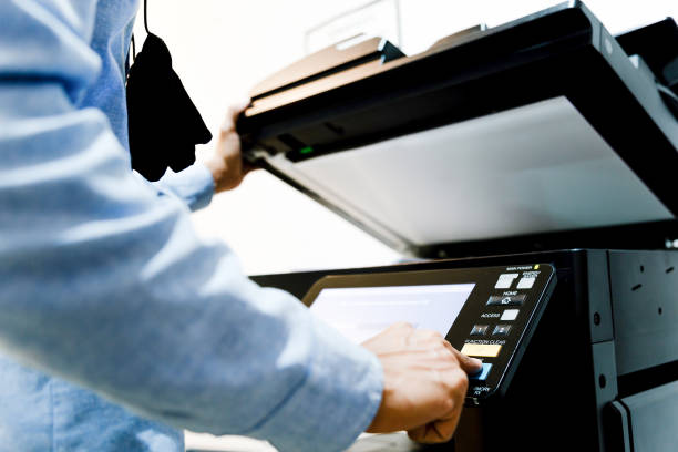 istock Bussiness man Hand press button on panel of printer, printer scanner laser in office copy machine supplies start concept. 1308192466