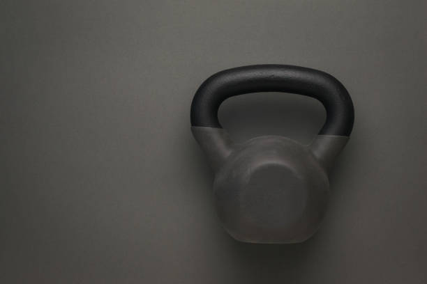 istock Sports kettlebell covered with rubber on a dark gray background. 1308193346