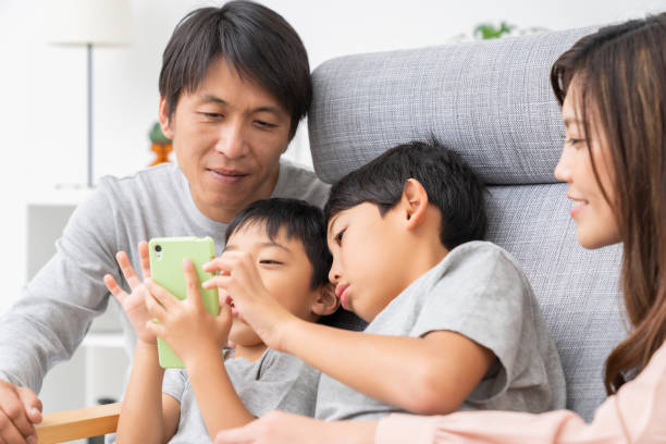 istock family looking at smart phone 1308194716
