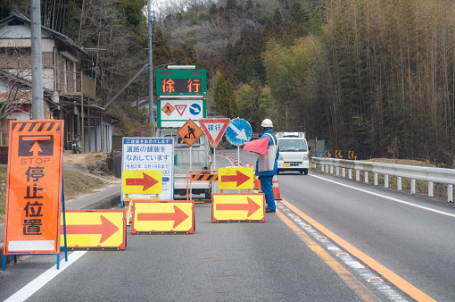 Photo of road construction. A photo of a traffic guide.
