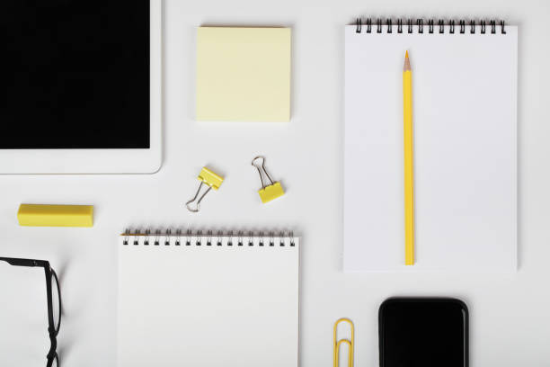 istock office table desk, workspace with digital tablet,mobile phone,notebook,yellow pencil,office supplies and eyeglass. Minimal concept. Flat lay,top view. 1308208790