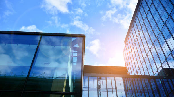 istock Modern office building with glass facade on a clear sky background. 1308208873