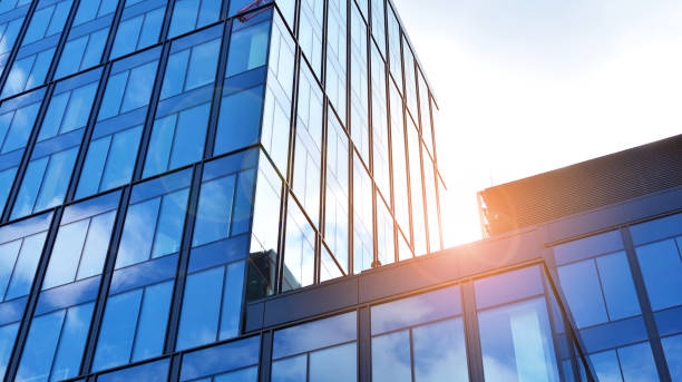 istock Modern office building with glass facade on a clear sky background. 1308208884