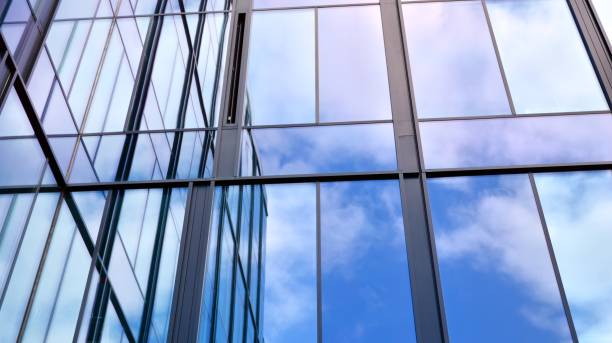 istock Modern office building with glass facade on a clear sky background. 1308208899