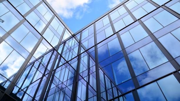 istock Modern office building with glass facade on a clear sky background. 1308208910
