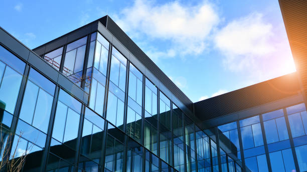 istock Modern office building with glass facade on a clear sky background. 1308208954