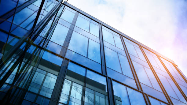 istock Modern office building with glass facade on a clear sky background. 1308208963