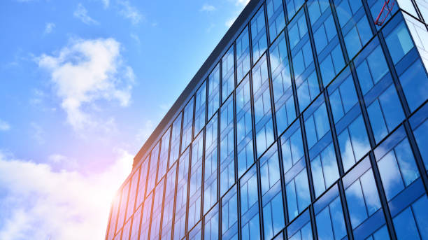 istock Modern office building with glass facade on a clear sky background. 1308208970