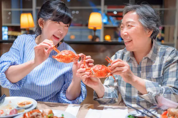 Photo of Happy mother and daughter having fun in  restaurant