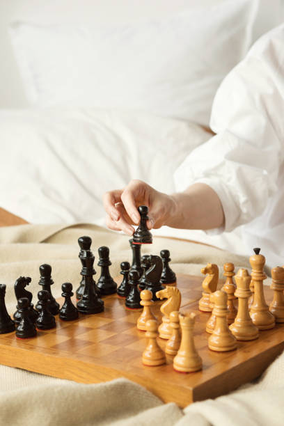 istock Chess Player Woman Hand. Black Pawn Step Forward 1308214719