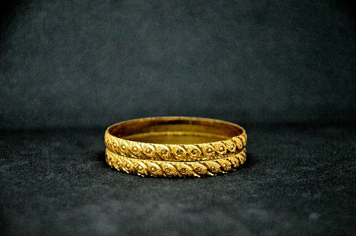 Stack of gold ornamental bracelet