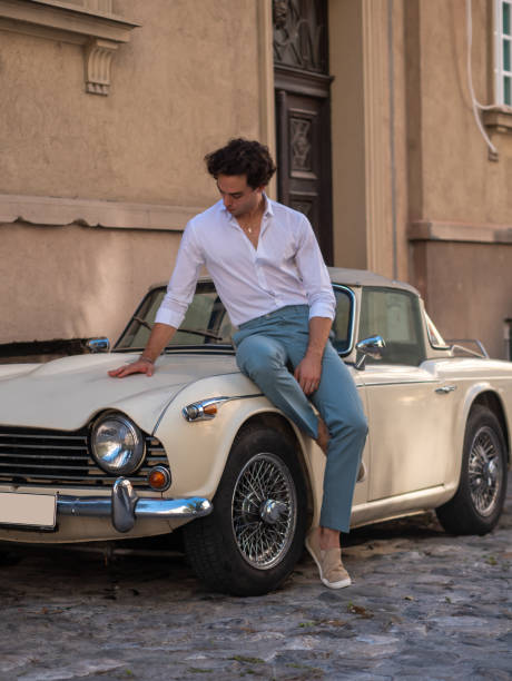 istock Young man and convertible vintage car. 1308215219