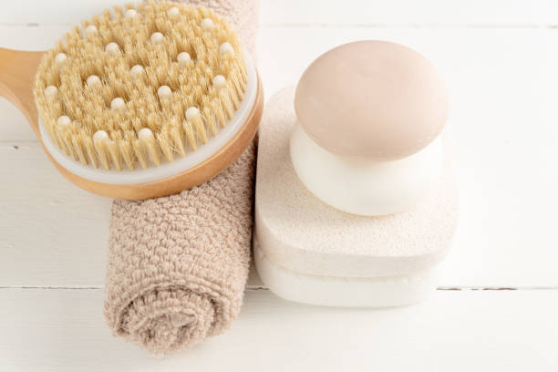 istock Spa, beauty cosmetics and body care treatment concept. Creative composition with bath accessories - massaging brush, soap bars and sponges on white background. 1308216800